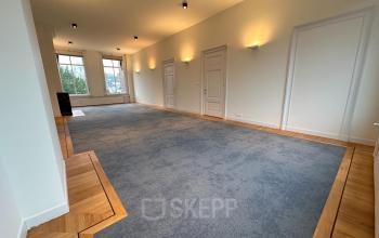 Spacious unfurnished office for rent with carpeted floors and large windows at Dreef 36 in Haarlem Zuid, Haarlem.