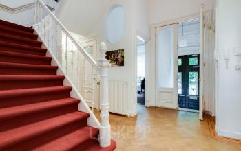 Spacious office to rent at Dreef 36, Haarlem Zuid, Haarlem with red-carpeted staircase and entrance leading to workspaces.