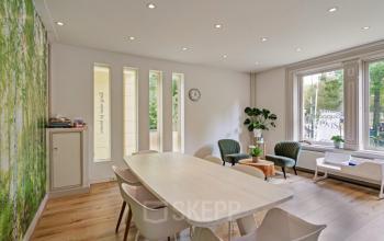 Bright office space at Florapark 7, Haarlem Zuid, Haarlem with large windows, modern furnishings, and nature-themed decor. Ideal for office space rental.