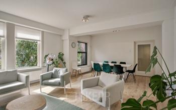 Modern office space rental with bright, furnished workspaces and seating area at Florapark 7, Haarlem Zuid.