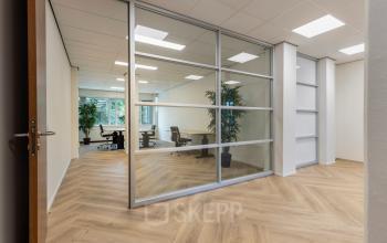 Modern office space with wooden flooring and glass partitions at Fonteinlaan 5, Haarlem Zuid, Haarlem, ideal for office space rental.
