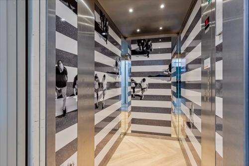 Elevator area with striped wall decor at an office building located at Fonteinlaan 5, Haarlem Zuid, Haarlem.