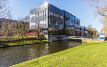 office building haarlem next to canal green environment