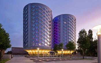 Modern architectural exterior of the office space rental at Suikersilo Oost-West 1-41 in Halfweg, highlighting its unique design during dusk.
