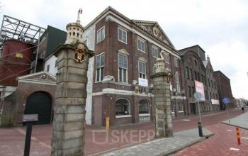 Exterior of the office building at Haarlemmerstraatweg 7, Halfweg, showcasing a historical facade with architectural details.