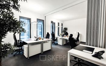 Modern office space at Überseeallee 1, Hamburg Hafencity with desks, chairs, and natural light, ideal for office space rental.