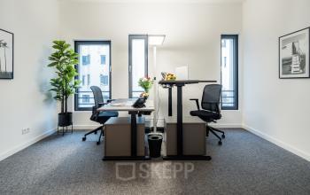 Modern office to rent in Hamburg Hafencity at Überseeallee 1, featuring sleek furnishings, standing desks, and vibrant decor. A perfect spot for dynamic work in a contemporary setting.