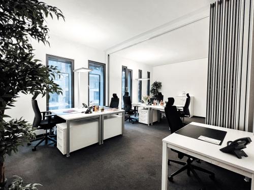 Modern office space at Überseeallee 1, Hamburg Hafencity with desks, chairs, and natural light, ideal for office space rental.