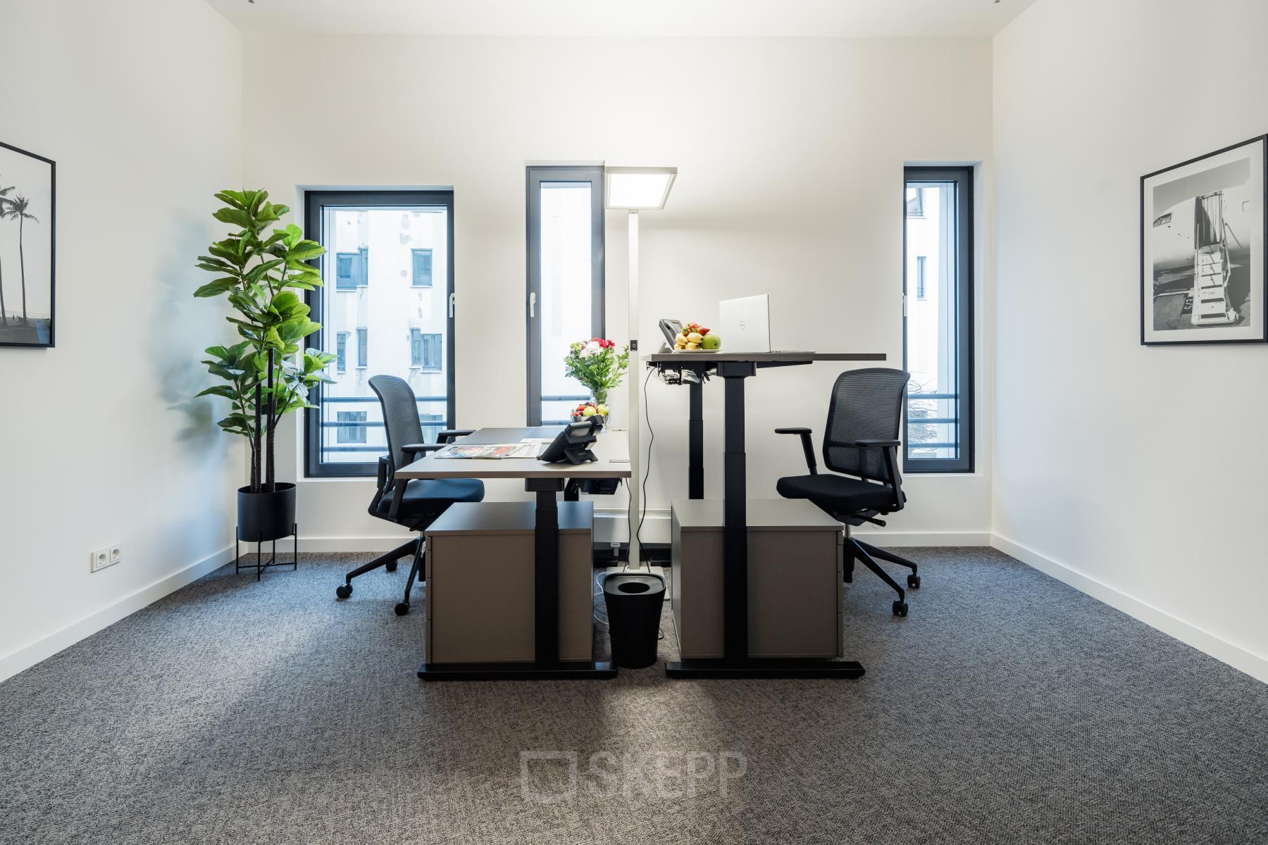 Modern office to rent in Hamburg Hafencity at Überseeallee 1, featuring sleek furnishings, standing desks, and vibrant decor. A perfect spot for dynamic work in a contemporary setting.