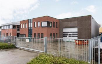 Modern office space rental at Techniekweg 2 in Harmelen, featuring a brick facade with large windows and an industrial-style entrance.