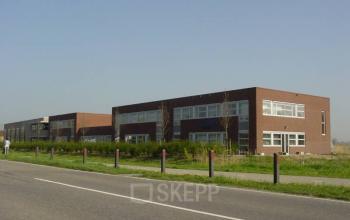 Modern office building available for office space rental at Techniekweg 2, Harmelen with a clear sky in the backdrop.
