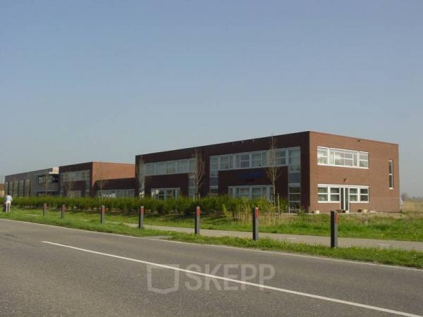 Modern office building available for office space rental at Techniekweg 2, Harmelen with a clear sky in the backdrop.