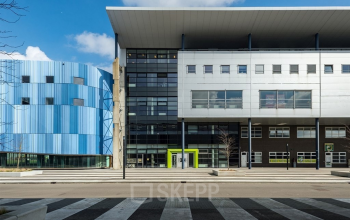 Modern exterior view of the office building on Milaanstraat 70-110, Heerlen, featuring contemporary architecture with sleek lines and contrasting colors, ideal for office space rental.