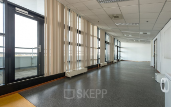 Spacious open floorplan at Milaanstraat 70-110, Heerlen, ideal for office space rental. Large windows provide ample natural light, creating an inviting atmosphere for productivity.