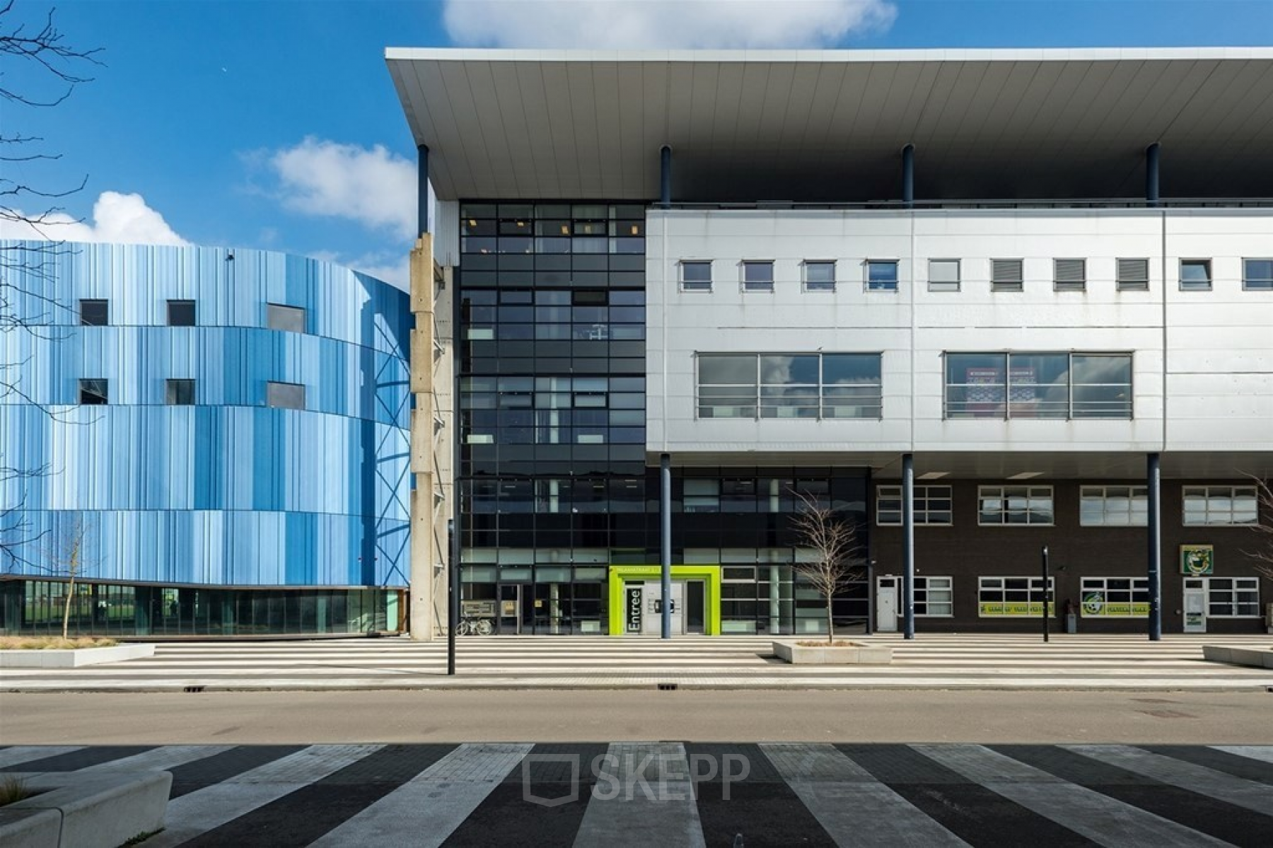 Modern exterior view of the office building on Milaanstraat 70-110, Heerlen, featuring contemporary architecture with sleek lines and contrasting colors, ideal for office space rental.