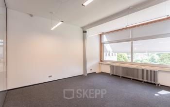 Bright office space with large windows, carpeted floor, and ceiling lights at Oliemolenstraat 60, Heerlen, available for office space rental.