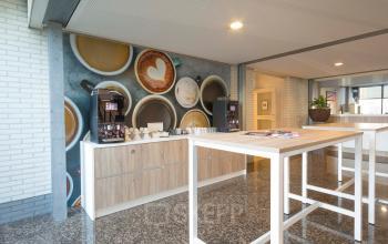 Modern pantry area in an office to rent at Steenovenweg 5, Helmond, featuring coffee machines and a large table.