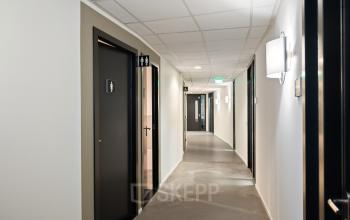 Interior hallway of office building at Lintelerweg 40 in Hengelo, featuring several doors and modern lighting, ideal for office space rental.