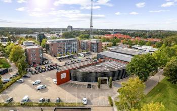 Aerial view of Lintelerweg 40, Hengelo, showcasing multiple office buildings with parking spaces for office space rental.