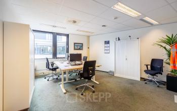Furnished office space at Welbergweg 60 in Hengelo, featuring desks and chairs, ideal for rent office space needs.