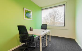 Bright office space with two desks and a large window located at Atealaan 34A, Herentals.