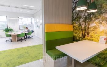 Modern office space rental at Atealaan 34A in Herentals with bright, colorful seating areas and spacious workstations.