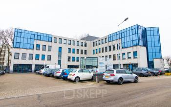 Exterior view of an office building at Franciscusweg 219, Hilversum, ideal for rent office space with ample parking.