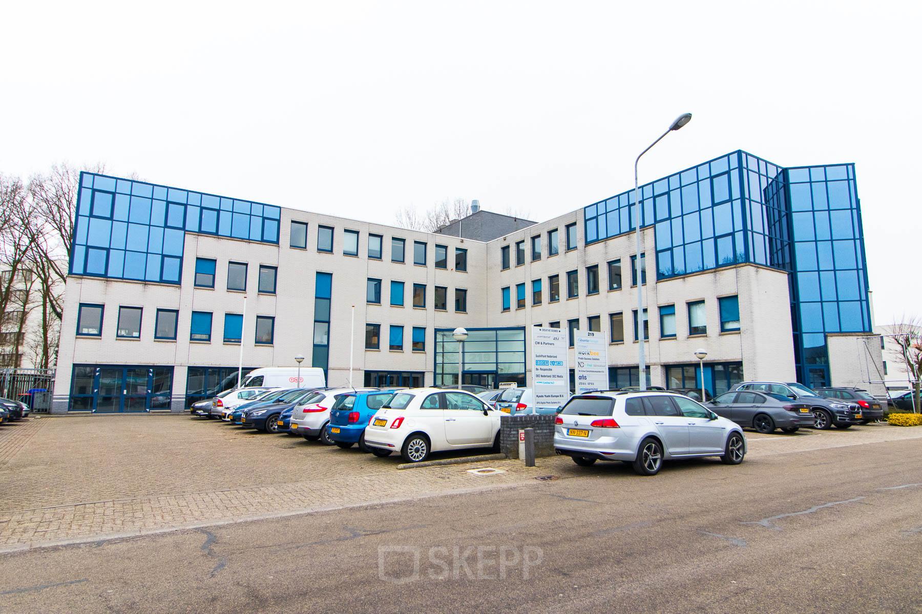 Exterior view of an office building at Franciscusweg 219, Hilversum, ideal for rent office space with ample parking.