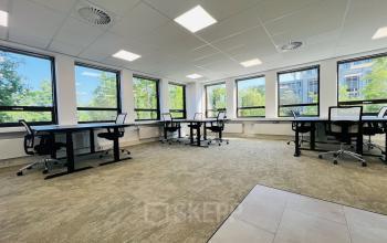 Spacious office to rent at Marathon 2, Hilversum, featuring large windows, several desks, and ergonomic chairs for optimal office space rental.