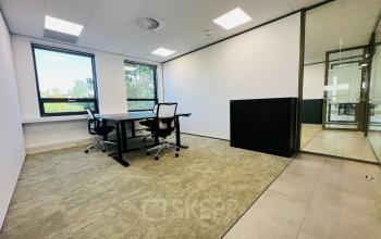 A bright office to rent at Marathon 2, Hilversum, featuring desks, chairs, and ample natural light. Ideal for office space rental needs.