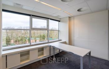 Bright office space at Olympia 4, Hilversum with large windows offering natural light and outdoor views. Ideal for small teams or individual work. Perfect office space rental for those seeking functionality.