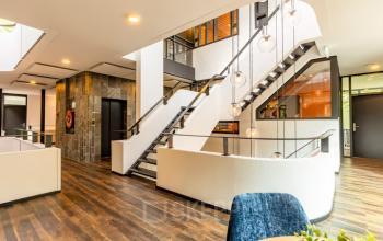 Interior of office space at Steijnlaan 16, Hilversum, featuring a modern staircase and stylish lighting, available for office space rental.