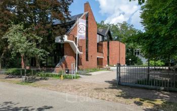 Exterior view of an office building at Steijnlaan 16, Hilversum, showcasing a modern brick design. Ideal for office space rental.