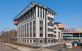 Modern multi-story office building at Olympia 2D, Hilversum, offering office space rental with ample windows and a dynamic structure.