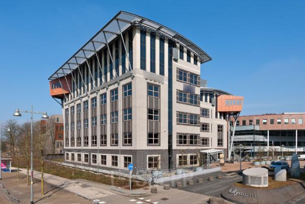 Modern multi-story office building at Olympia 2D, Hilversum, offering office space rental with ample windows and a dynamic structure.