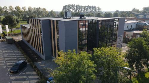 Exterior view of an office building at Catharina van Renneslaan 8-10, Hilversum, showcasing sleek design and reflective windows ideal for office space rental.