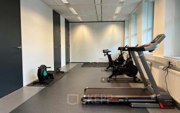 Office to rent at De Wel 20, Hoevelaken features a workout area with exercise equipment including a treadmill and stationary bikes, ideal for office space rental with fitness facilities.