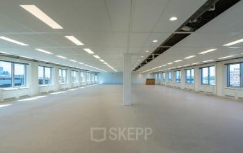 Spacious, light-filled office space with numerous windows and overhead lighting at Polarisavenue 1, Hoofddorp, ideal for office space rental.