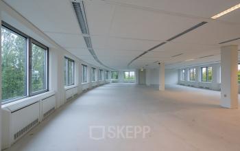 Spacious unfurnished office to rent at Polarisavenue 1, Hoofddorp, featuring large windows and ample natural light.