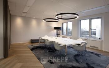 Sleek, modern conference room with a large table and eight chairs at Polarisavenue 1, Hoofddorp, ideal for office space rental.