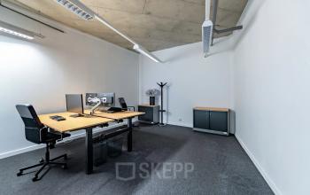 Furnished office space for rent at Opaallaan 1180, Hoofddorp, featuring modern desks, chairs, and computers in a well-lit interior.