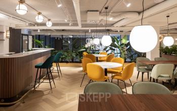 Modern, stylish workspace at Siriusdreef 60, Hoofddorp featuring contemporary seating, vibrant decor, and greenery ideal for office space rental. The decor encourages creativity and collaboration.