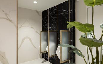 Modern restroom with elegant black marble partitions and green plant accents, located at Siriusdreef 60 in Hoofddorp, available for office space rental.
