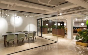 Modern office space with glass-walled conference room and stylish wooden dividers, offering a versatile workspace in Siriusdreef 60, Hoofddorp. Ideal for businesses looking for an office space rental with an elegant touch.