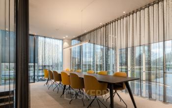 Bright, furnished conference room with a long table and yellow chairs, available for office space rental at Taurusavenue 1-41, Hoofddorp.