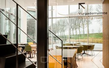 Bright meeting room at Taurusavenue 1-41, Hoofddorp with large windows, modern furniture, and scenic views, ideal for office space rental.