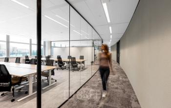 Spacious office interior at Taurusavenue 1-41 in Hoofddorp, showcasing a modern workspace with glass partitions and sleek furniture. Ideal office space rental for professionals.