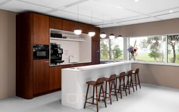 Modern office kitchen with a sleek bar and stools at Taurusavenue 1-41 in Hoofddorp, ideal for rent office space needs. Large window provides natural light.