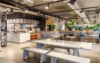 Spacious office space at Siriusdreef 16, Hoofddorp, featuring modern furnishings with a mix of tables and plants. Ideal for office space rental with comfortable work opportunities.