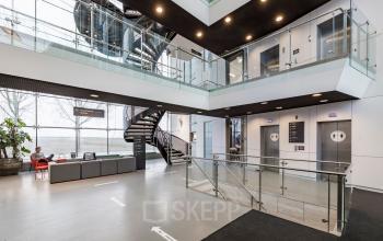 Modern lobby at Siriusdreef 16 in Hoofddorp featuring elevators and seating, ideal for office space rental.
